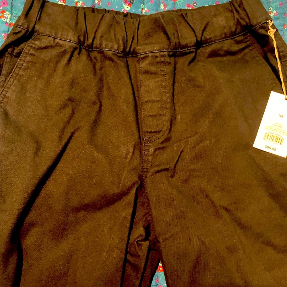 Black pants with stretchy waistband pockets in front and back .